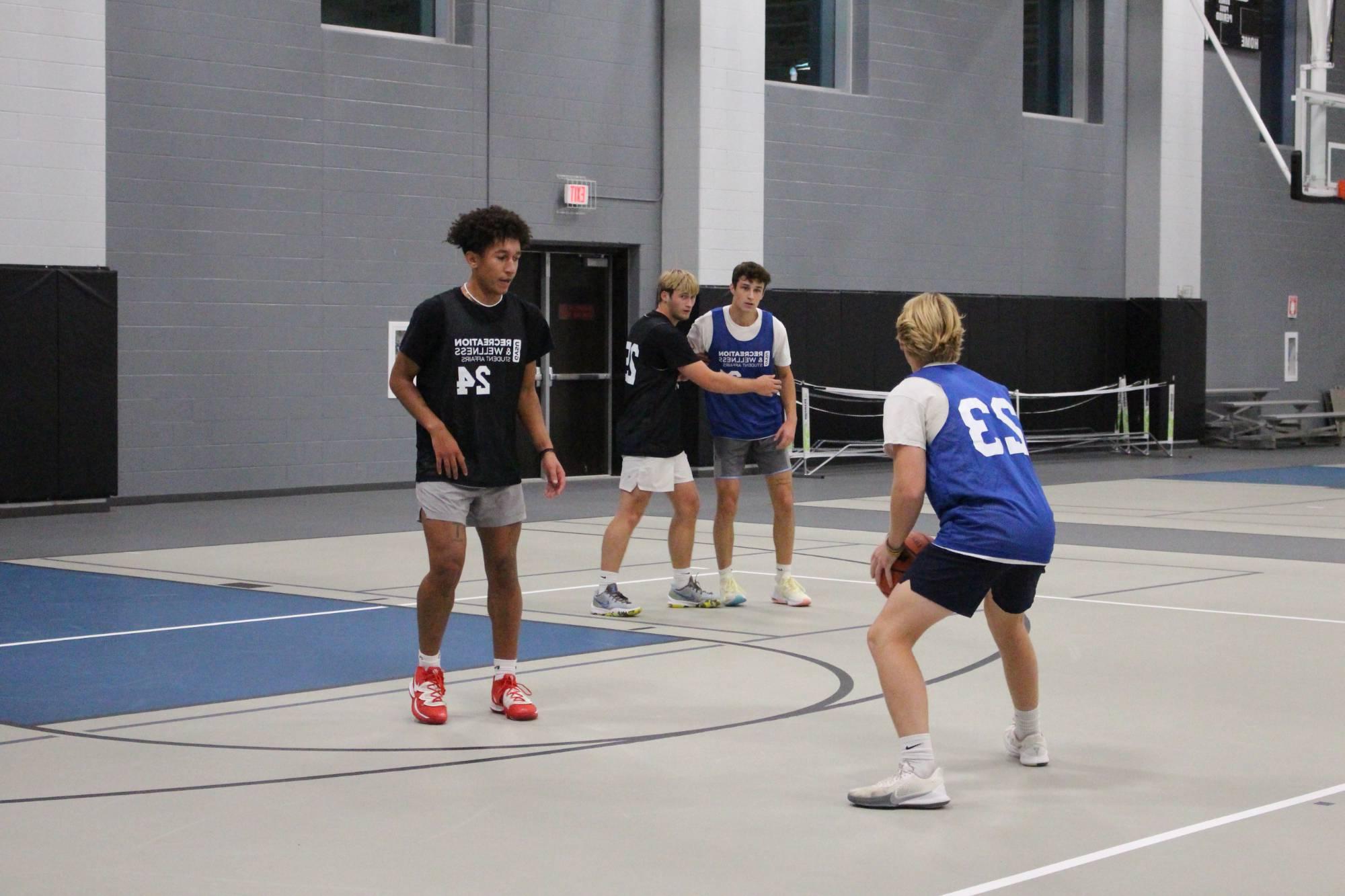 baketball player dribbling and being guarded by defense